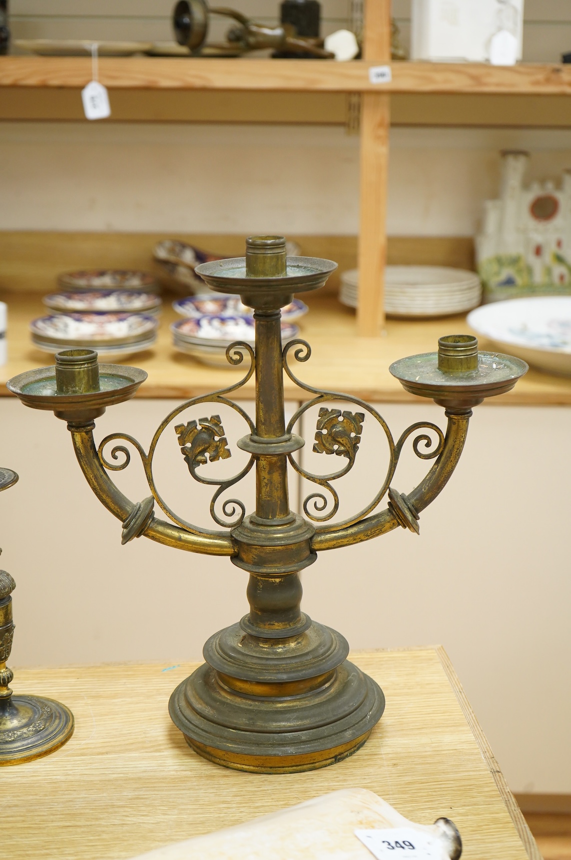 A pair of two brass branch, three light candelabra and two other brass candlesticks, largest 38cm high